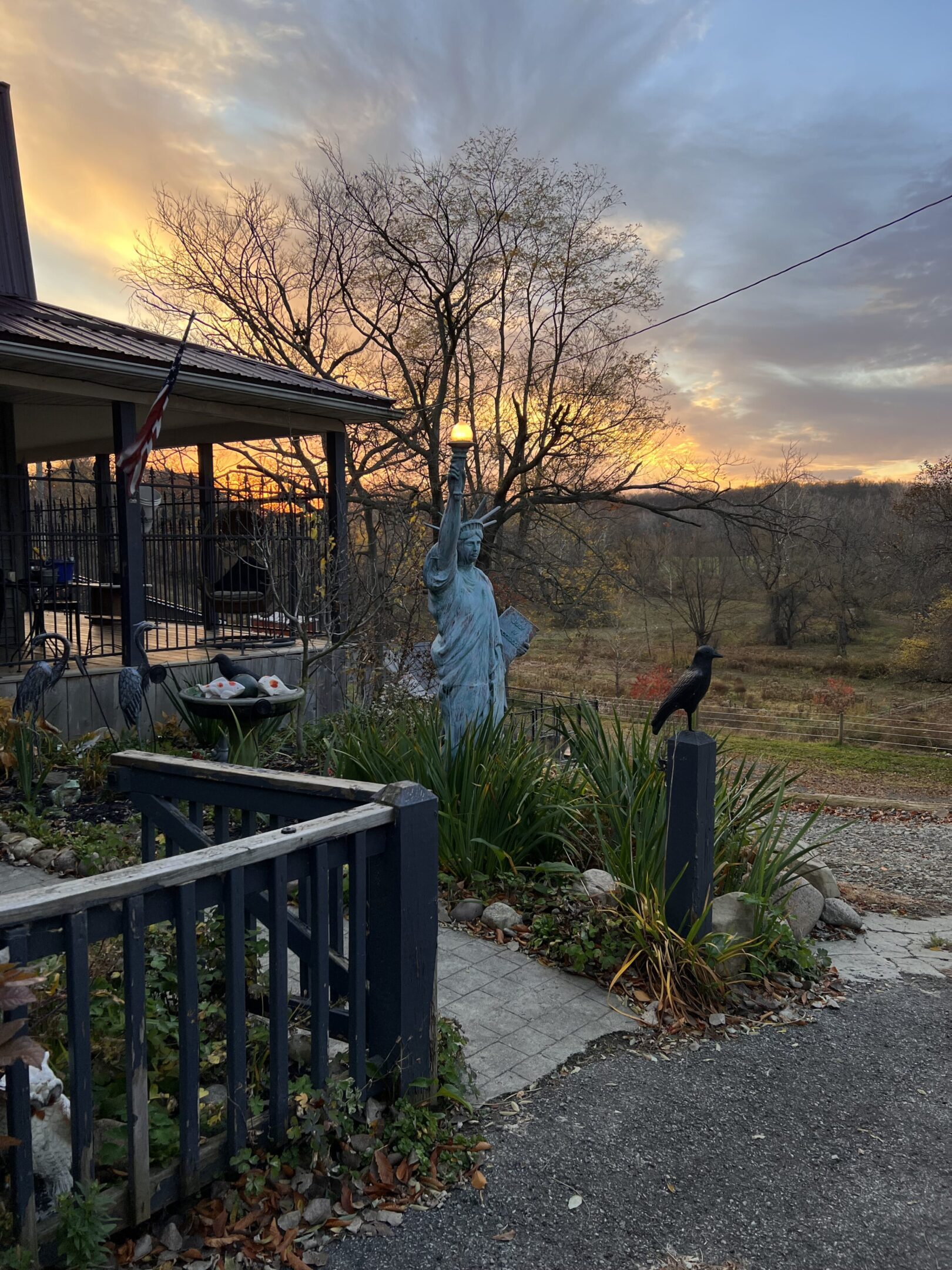 A statue of liberty is painted on the side of a house.